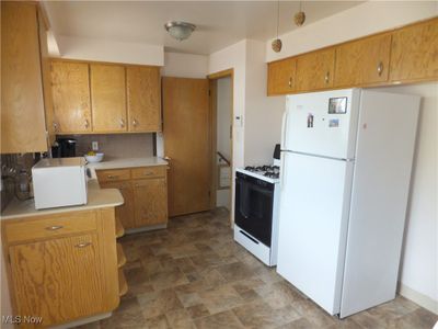 Kitchen featuring white appliances and decorative backsplash | Image 3