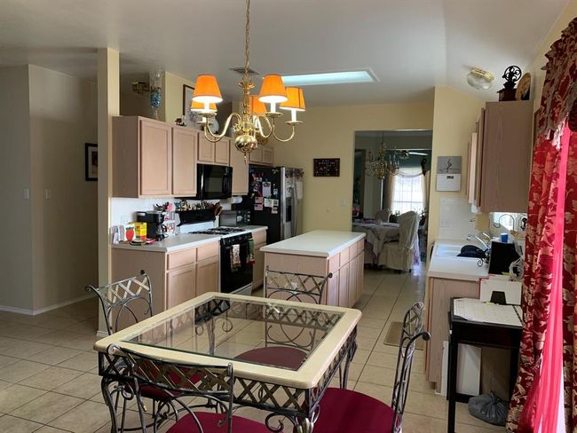 Kitchen and dining area have an open design for ideal for entertaining. | Image 8