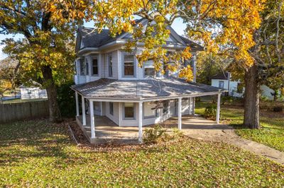 Back of property featuring covered porch and a lawn | Image 2