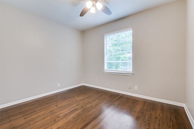 Secondary Bed room with baseboards, a ceiling fan, and dark real wood flooring | Image 18