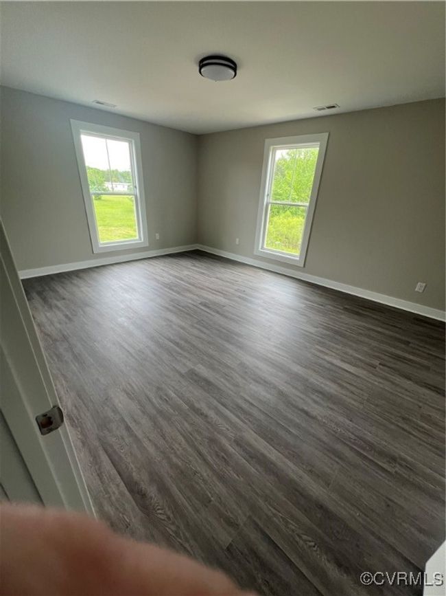 Spare room with baseboards, a wealth of natural light, and dark wood-style floors | Image 16
