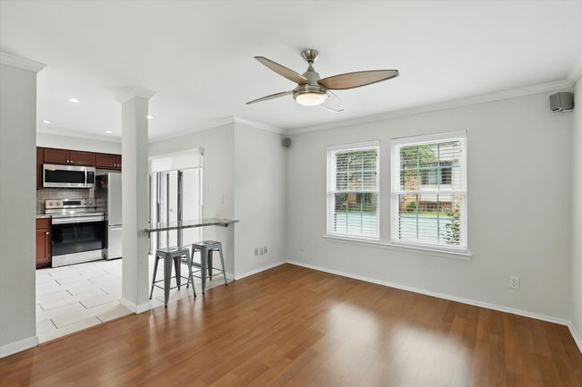 Spare room with a ceiling fan, light wood finished floors, recessed lighting, ornamental molding, and baseboards | Image 7