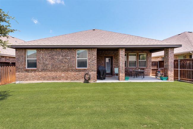Back of property featuring a fenced backyard, brick siding, a patio, and roof with shingles | Image 36