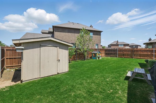 View of yard with an outbuilding, a fenced backyard, and a storage unit | Image 33