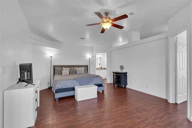 Bedroom with dark wood-style floors and ensuite bath | Image 15