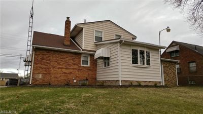 Back of property with central air condition unit and a lawn | Image 2