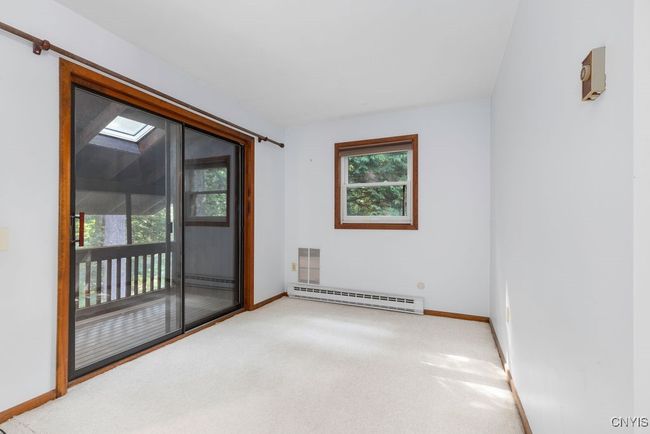 Covered and screened deck off of the primary bedroom sitting area! | Image 31