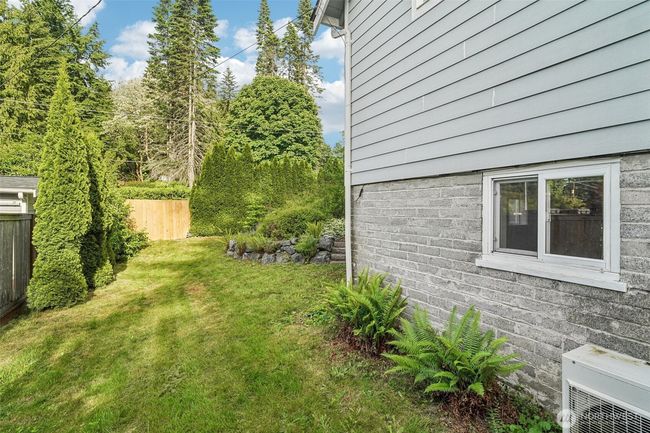 Side yard with fence onto street. Was once a driveway. Potential to reinstate & use as separate driveway/ RV parking to basement entrance. | Image 21