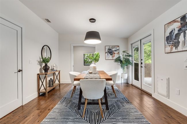 The dining area sits alongside the doors to the back patio and the home office, where you will find a built-in Murphy bed. | Image 21