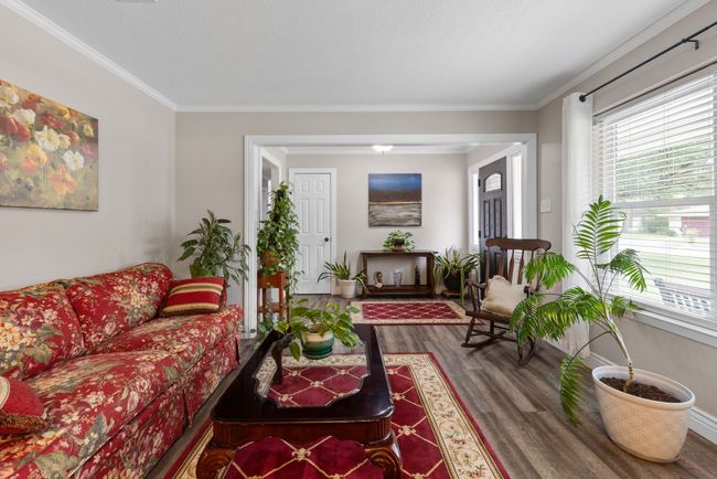 Living area featuring wood finished floors, healthy amount of natural light, and ornamental molding | Image 23