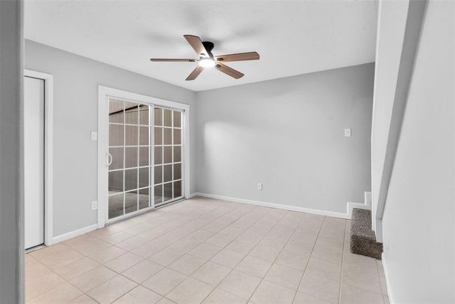 The spacious dining room with sliding glass doors to the patio. | Image 12