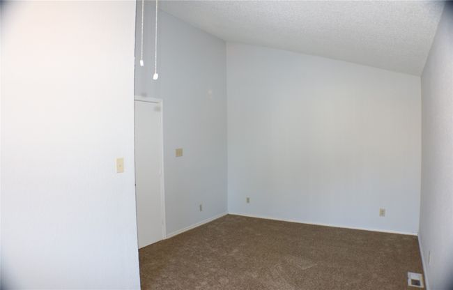 Empty room featuring a textured ceiling and carpet floors | Image 4