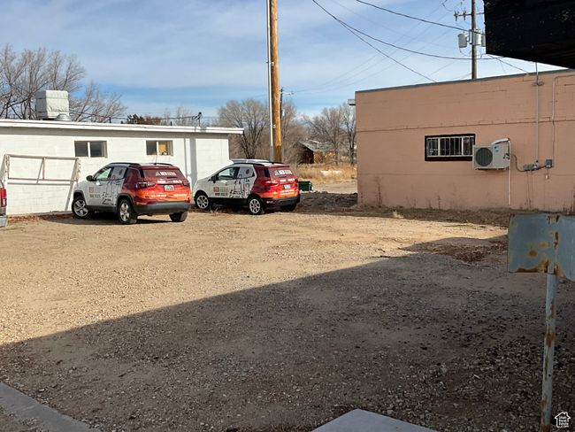View of car parking featuring ac unit | Image 9