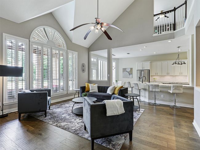 Living room with hardwood / wood-style floors, a ceiling fan, and high vaulted ceiling | Image 21
