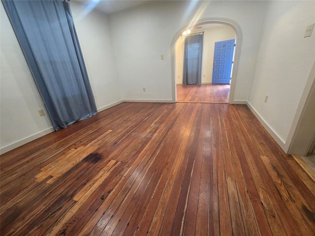 Unfurnished room with wood-type flooring and arched walkways | Image 23