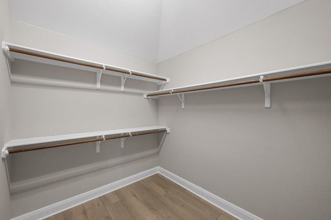 Walk in closet with wood finished floors | Image 16