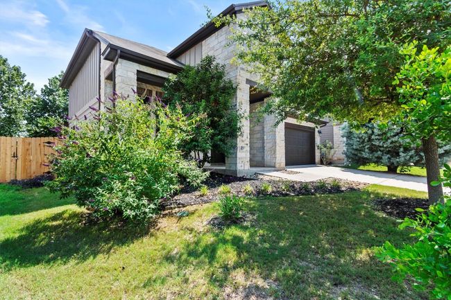 View of front facade featuring stone siding, driveway, and board and batten siding | Image 5