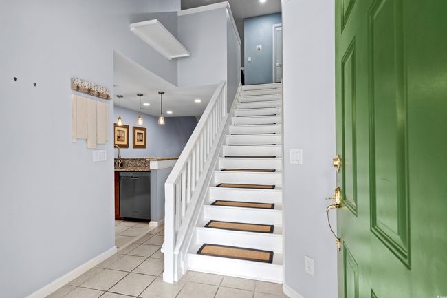 Staircase with tile patterned floors, baseboards, and recessed lighting | Image 4