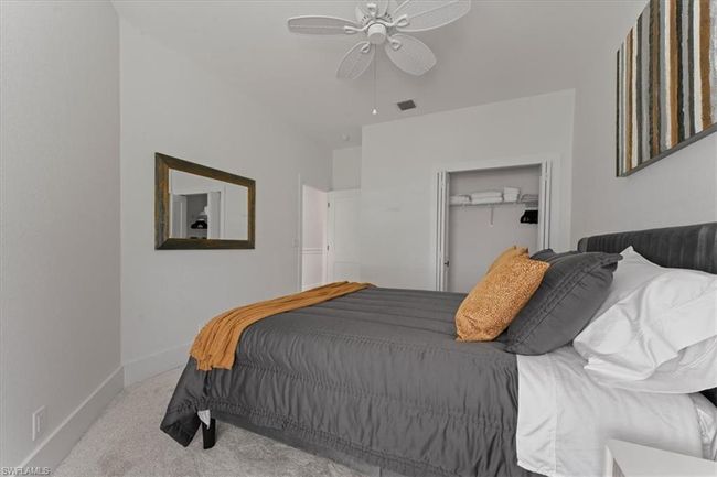 Carpeted bedroom with baseboards, a ceiling fan, and a closet | Image 28