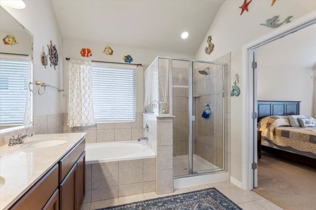 Primary bath has soaking tub and big window. | Image 22