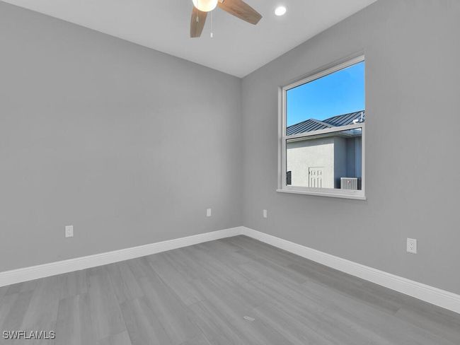 Empty room featuring wood finished floors, a ceiling fan, and recessed lighting | Image 24