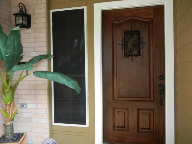 Mediterranean style wood entry door. | Image 5