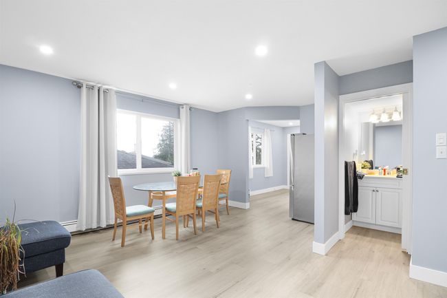 Dining area with baseboards, light wood-style floors, a baseboard heating unit, and recessed lighting | Image 14