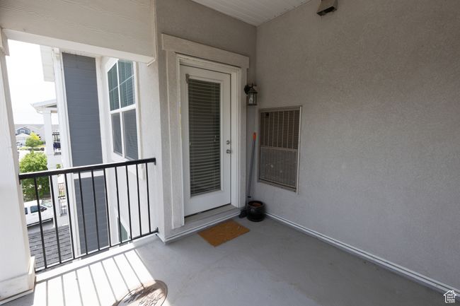 Property entrance featuring a balcony and stucco siding | Image 10