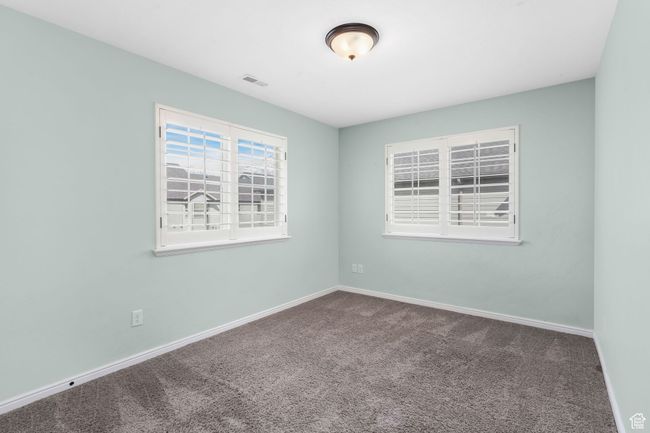 Carpeted spare room with baseboards and visible vents | Image 10
