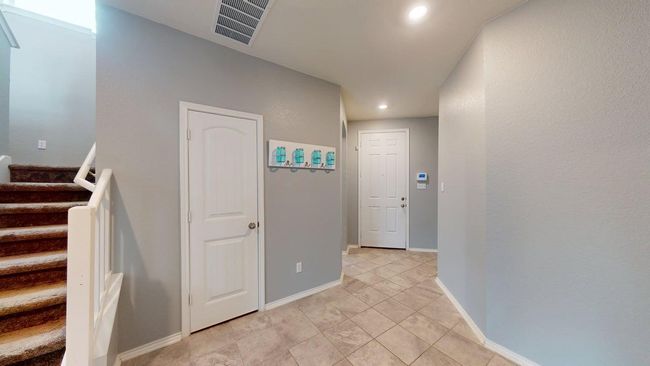 Hallway featuring recessed lighting, baseboards, light tile patterned floors, visible vents, and stairway | Image 5