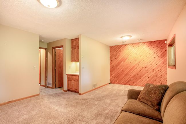 Spacious and functional, this lower level family room and den is ideal for movie nights, hobbies, or hosting guests. | Image 24
