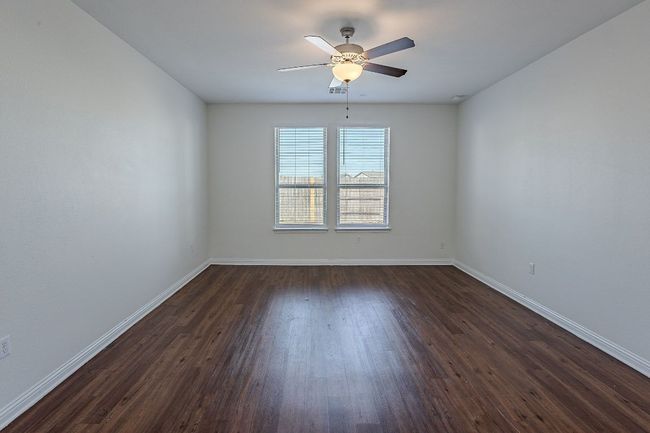 Unfurnished room featuring baseboards, ceiling fan, and dark wood finished floors | Image 13