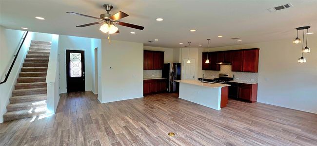 Living area, open floor plan and light wood-style flooring | Image 13