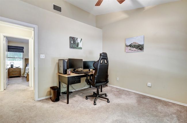 Carpeted home office featuring a ceiling fan and baseboards | Image 25
