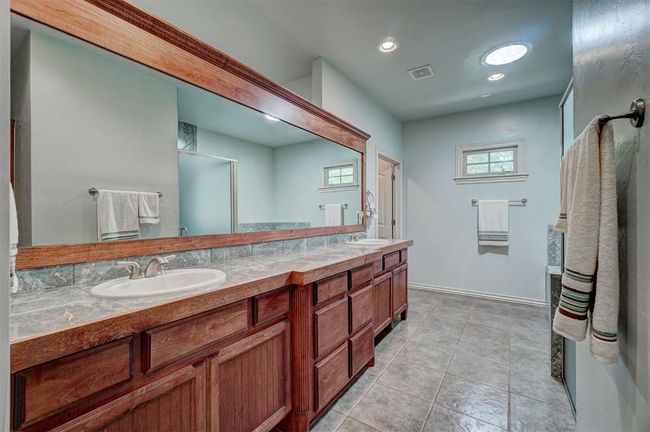 Full bathroom with baseboards, visible vents, a sink, and double vanity | Image 24
