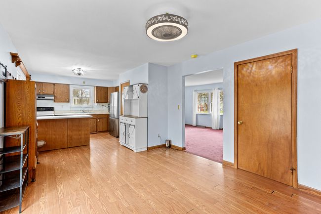view from dining into kitchen and living room | Image 13