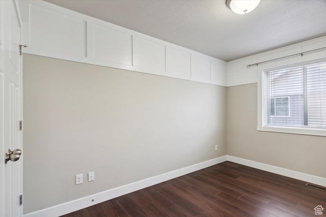 Unfurnished room with dark wood-style floors and baseboards | Image 27