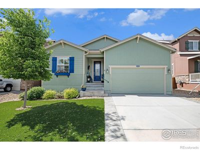 Front of the home featuring the HEATED DRIVEWAY, stamped concrete walkway and artificial turf. | Image 1