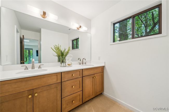 Full bath with double vanity, baseboards, and a sink | Image 32