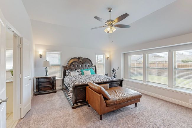 Bedroom with baseboards, a ceiling fan, and light carpet | Image 13