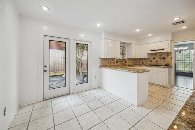 Breakfast room and kitchen open to side patio area | Image 7