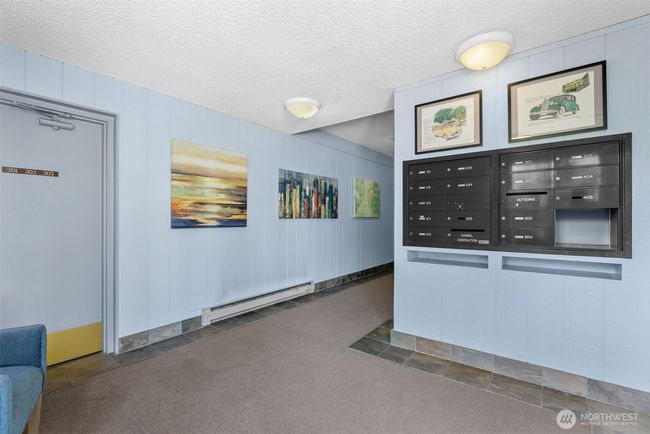 Secure lobby with mailboxes and a great community board with information around the corner. | Image 34