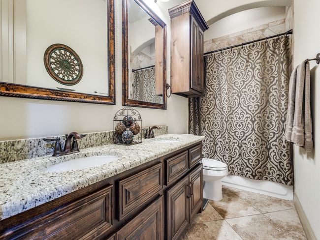 Bathroom featuring toilet, double vanity, and tile patterned floors | Image 18