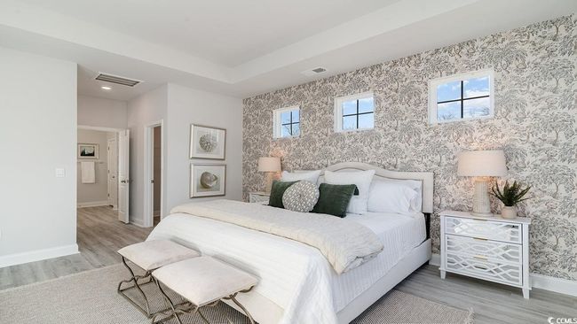 Bedroom with light hardwood / wood-style flooring and a tray ceiling | Image 24