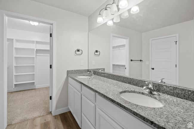 Full bathroom with double vanity, a spacious closet, and wood finished floors | Image 24