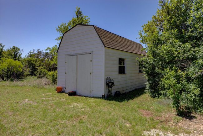 Extra storage shed provides room for riding mowers and gardening supplies. | Image 35