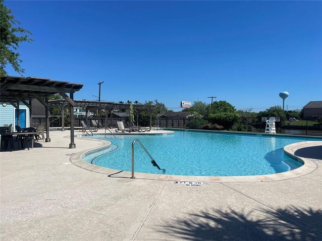Enjoy the neighborhood pool with ample shade and a dedicated baby pool for family fun. | Image 47