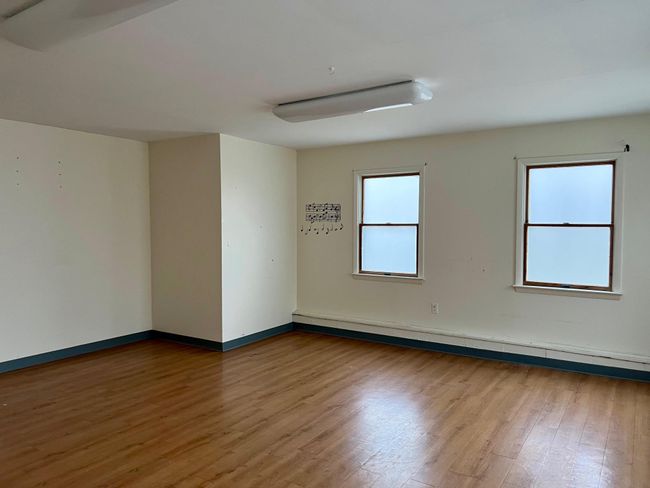 Unfurnished room featuring baseboard heating, baseboards, and wood finished floors | Image 11