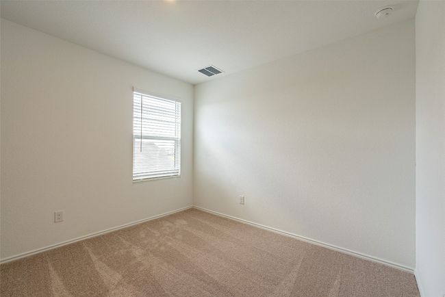 Empty room featuring light carpet, baseboards, and a smoke detector | Image 15