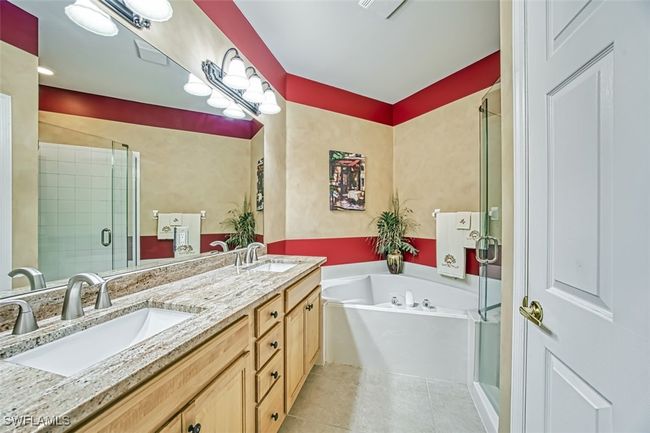 Bathroom featuring tile patterned flooring, vanity, and separate shower and tub | Image 31